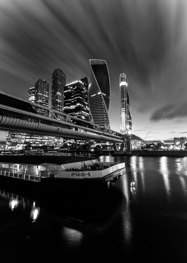 Monochrome Photo of Modern Skyscrapers and Bridge at Night - Free Images, Stock Photos and Pictures on Pikwizard.com