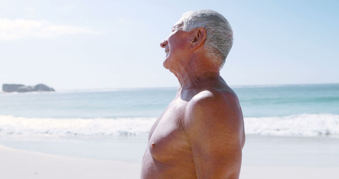 Senior Man Enjoying Sun at Beach, Relaxing and Laughing - Free Images, Stock Photos and Pictures on Pikwizard.com