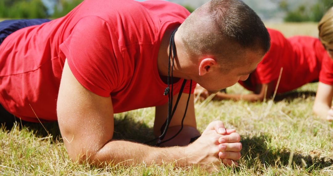 Man Doing Plank Exercise Outdoors in Red Shirt - Free Images, Stock Photos and Pictures on Pikwizard.com