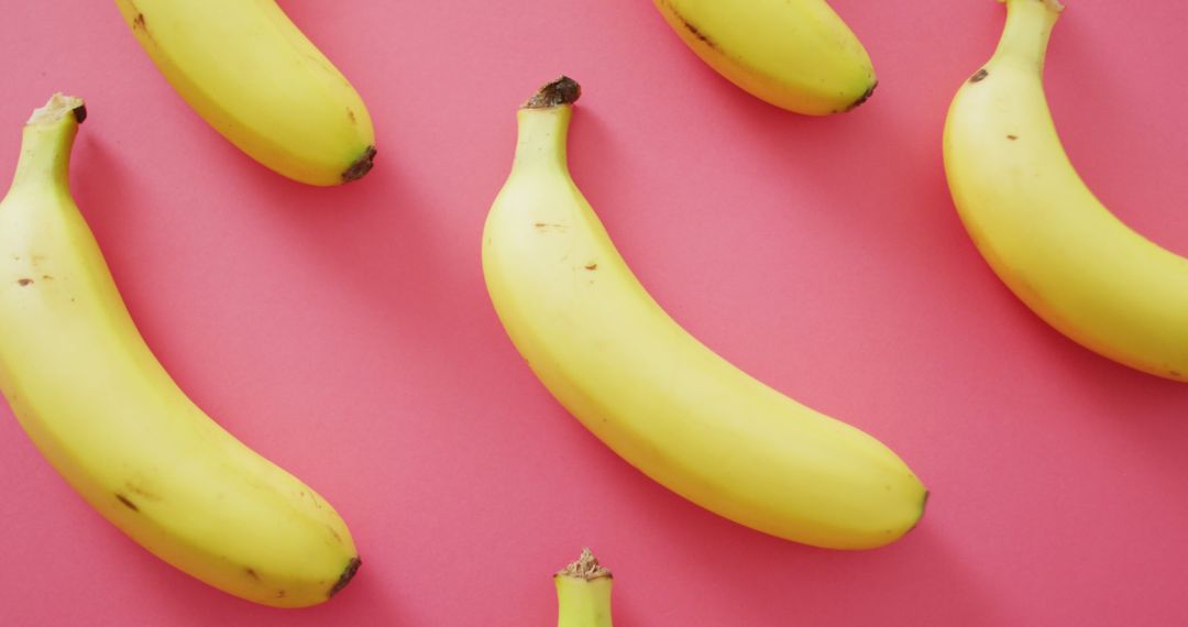 Fresh Yellow Bananas on Pink Background Creating Modern Look - Free Images, Stock Photos and Pictures on Pikwizard.com