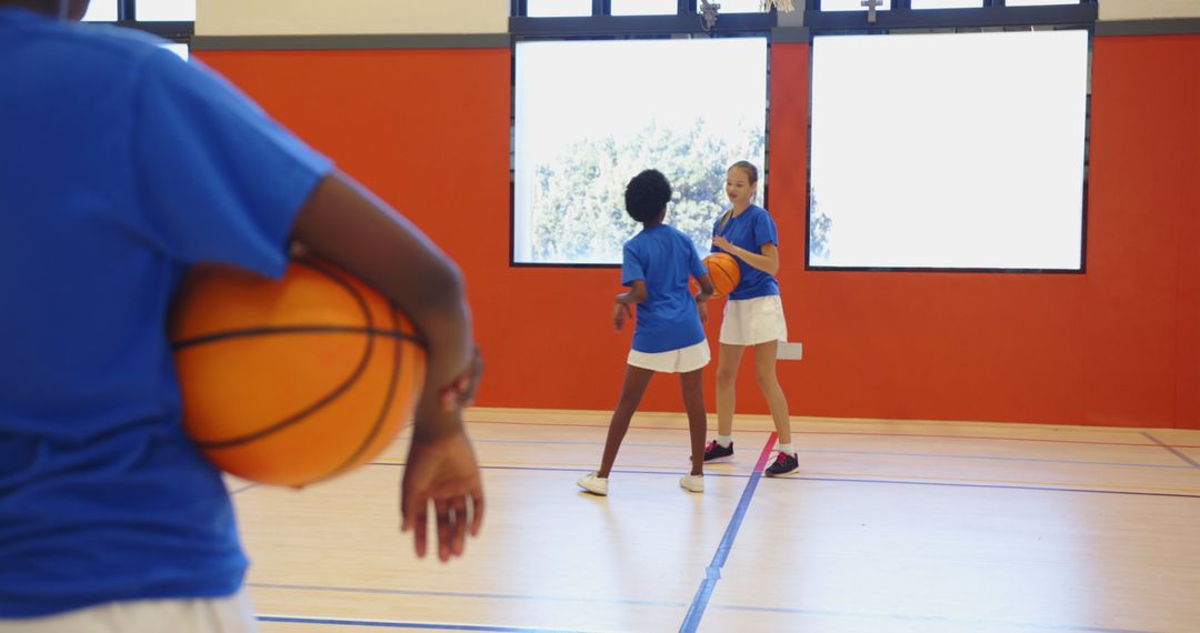 Diverse Middle School Girls Practicing Basketball in Gym