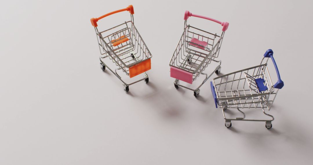 Three Miniature Shopping Carts on Grey Background - Free Images, Stock Photos and Pictures on Pikwizard.com