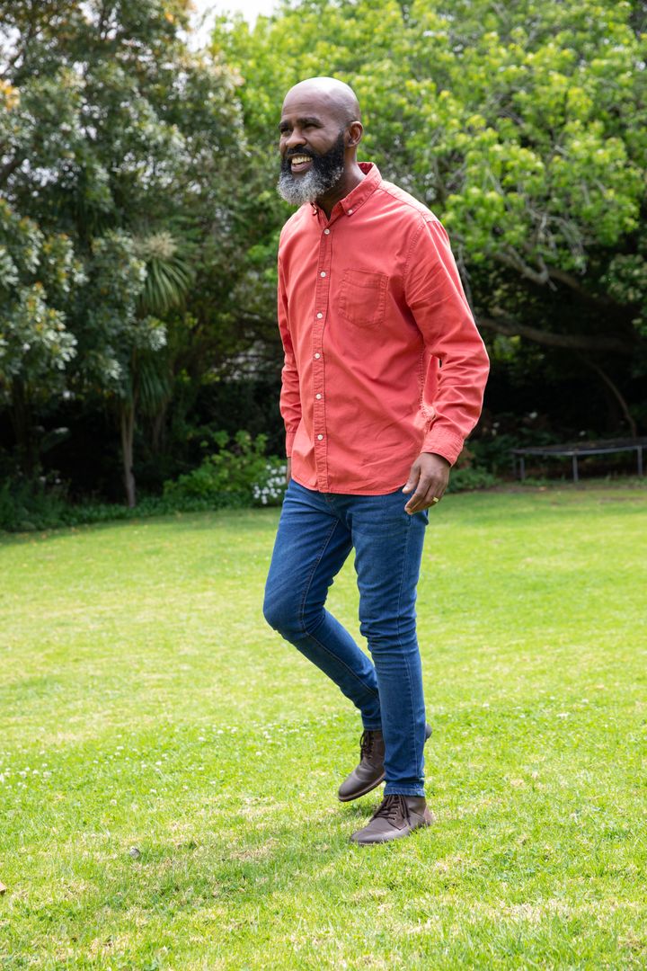Confident Man Strolling Through Lush Green Backyard