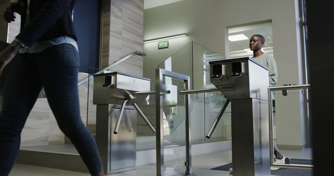 Two Women Using Turnstile at Office Entrance for Security Check - Free Images, Stock Photos and Pictures on Pikwizard.com