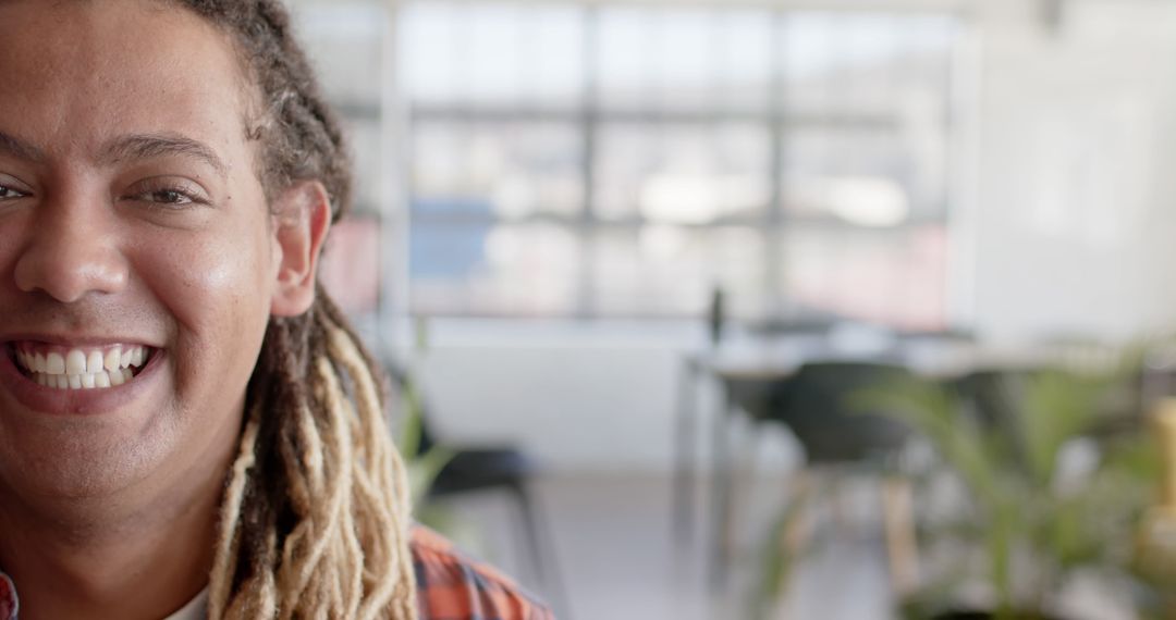 Portrait of happy biracial businessman with dreadlocks smiling at office, copy space - Free Images, Stock Photos and Pictures on Pikwizard.com