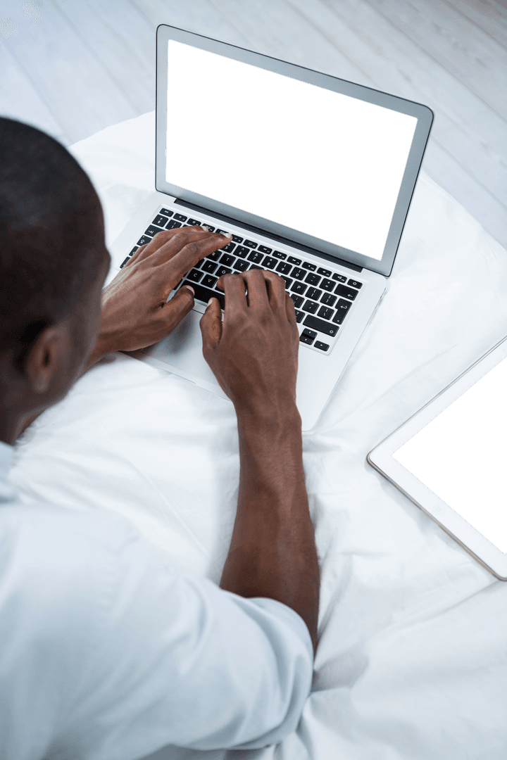 Transparent View of Man Typing on Laptop in Bed Environment