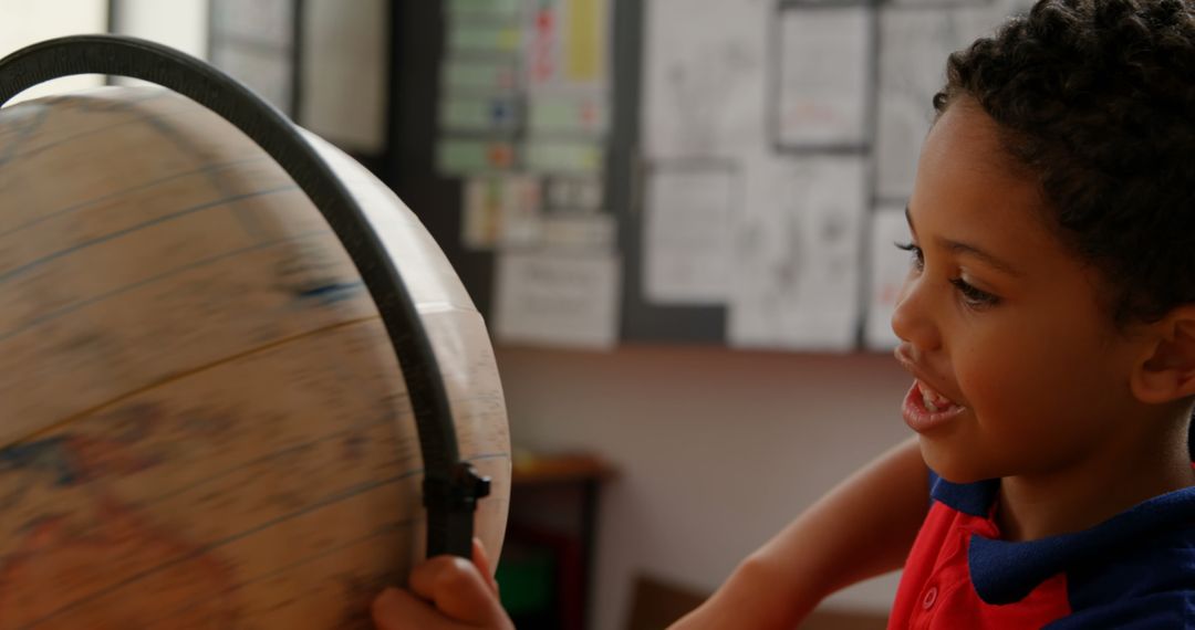 Curious Schoolboy Exploring World with Globe in Classroom