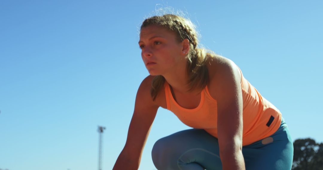 Determined Female Athlete Ready for Running Start Outdoors - Free Images, Stock Photos and Pictures on Pikwizard.com