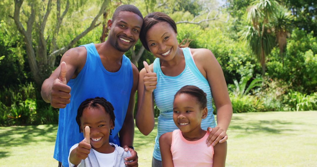 Happy African American family giving thumbs up in park on sunny day - Free Images, Stock Photos and Pictures on Pikwizard.com