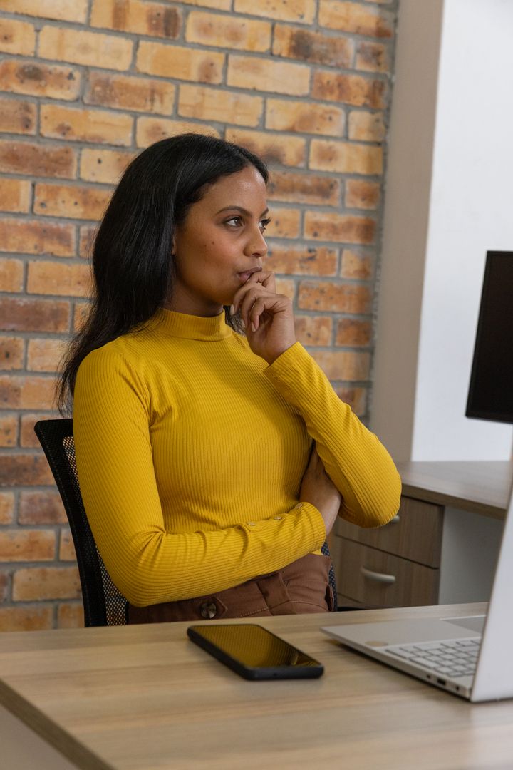 Confident Businesswoman Envisioning Success at Modern Workspace