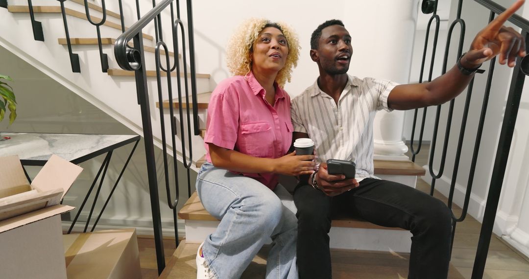 Happy Couple Relaxing During Move on Stairs