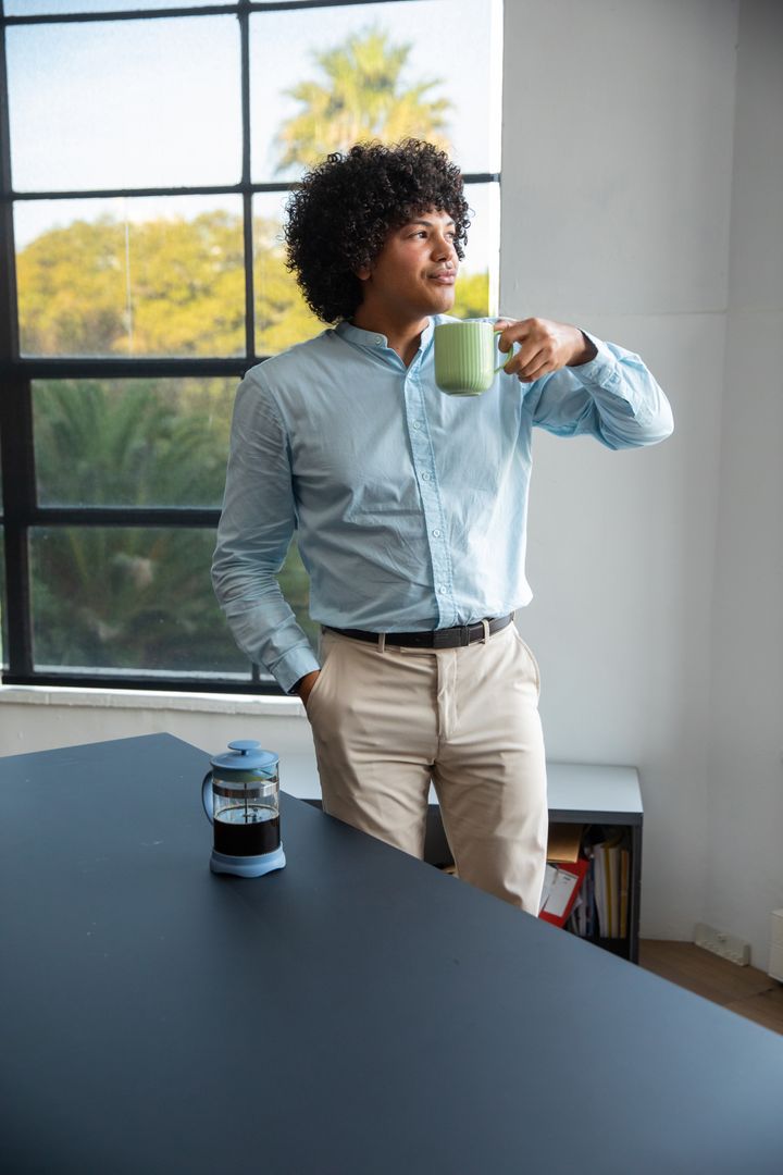 Confident Professional Enjoying Coffee Break at Modern Office