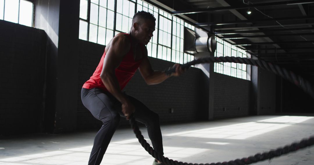 Determined African American Athlete Exercising with Battle Ropes in Gym - Free Images, Stock Photos and Pictures on Pikwizard.com