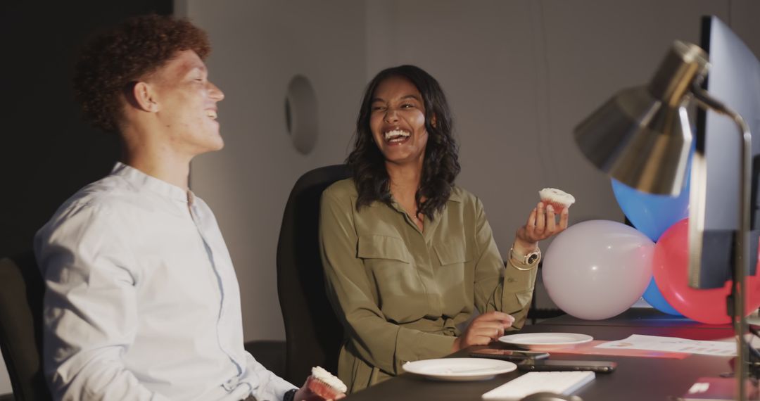 Diverse Colleagues Laughing and Enjoying Cupcakes in Office