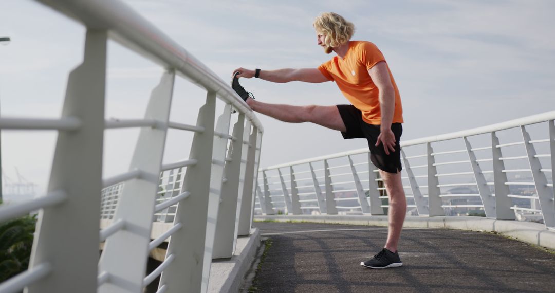 Young Man Stretching on Bridge During Morning Workout - Free Images, Stock Photos and Pictures on Pikwizard.com