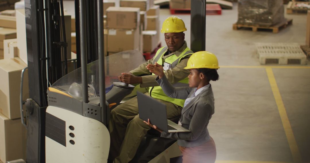 Warehouse Supervisor Instructing Worker Operating Forklift - Free Images, Stock Photos and Pictures on Pikwizard.com