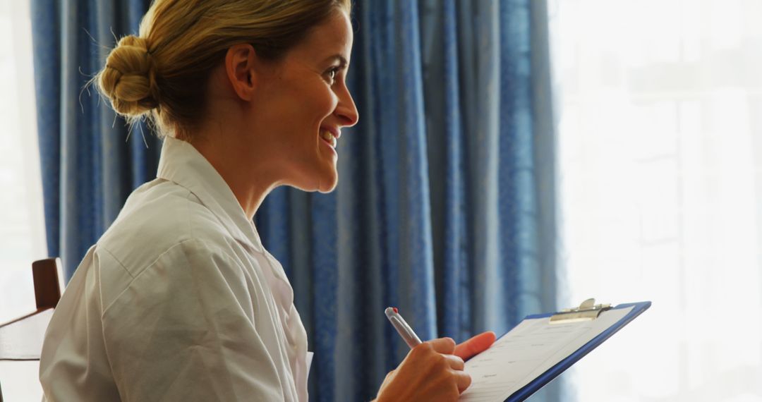 Smiling Nurse Holding Clipboard in Hospital Room - Free Images, Stock Photos and Pictures on Pikwizard.com