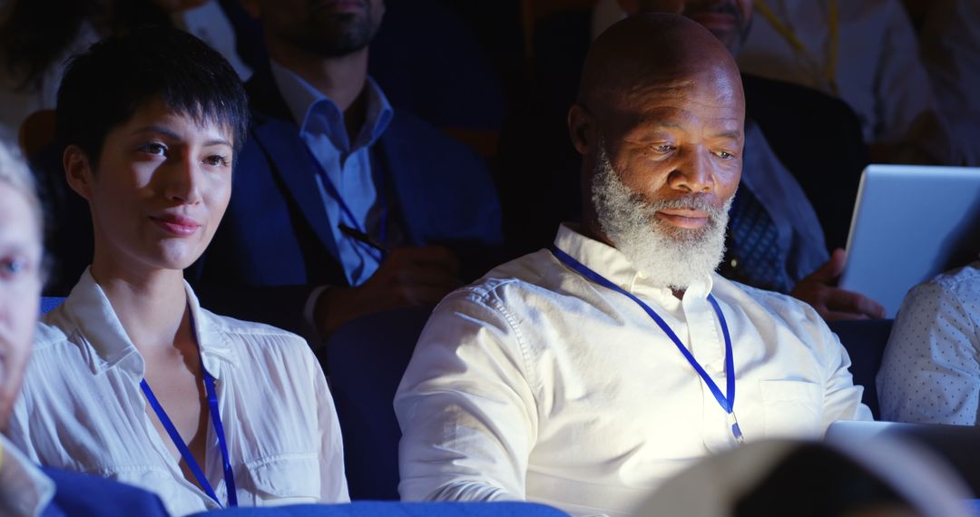 Diverse Professionals Engaged in Business Seminar Using Laptop