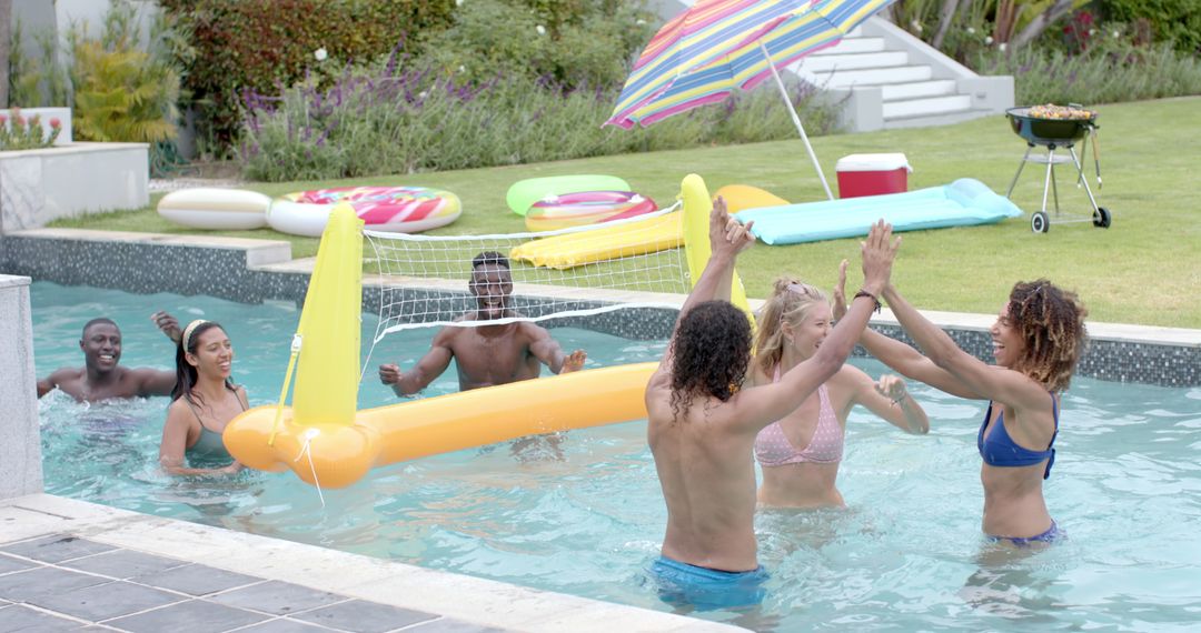Diverse Group Enjoying Pool Volleyball Game on Sunny Day