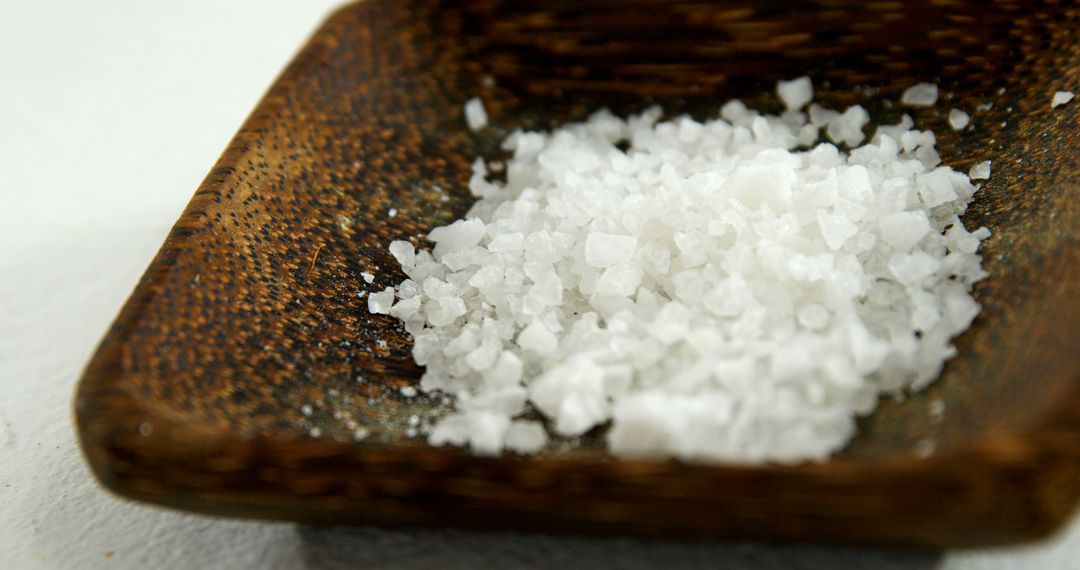 Close-Up of Coarse Sea Salt in Wooden Bowl on White Background - Free Images, Stock Photos and Pictures on Pikwizard.com