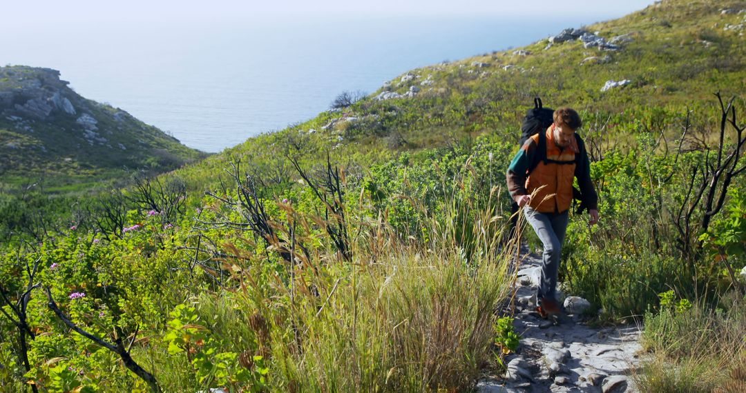 Man Hiking on Mountain Trail with Scenic Ocean View - Free Images, Stock Photos and Pictures on Pikwizard.com