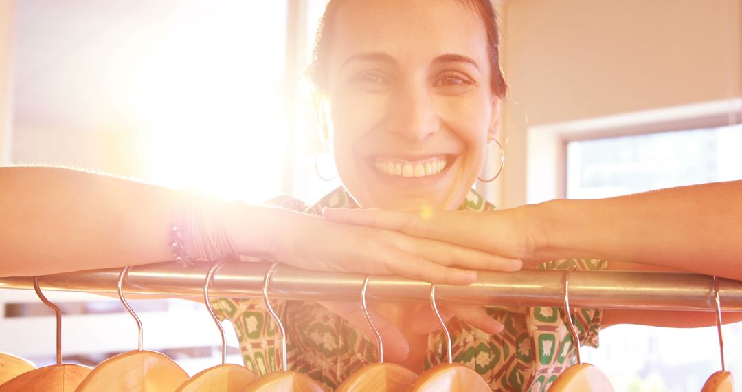 Smiling Woman in Sunlit Retail Store - Free Images, Stock Photos and Pictures on Pikwizard.com