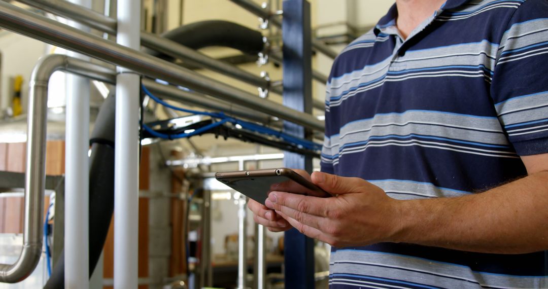 Factory Worker Using Tablet for Technical Inspections in Industrial Setting - Free Images, Stock Photos and Pictures on Pikwizard.com