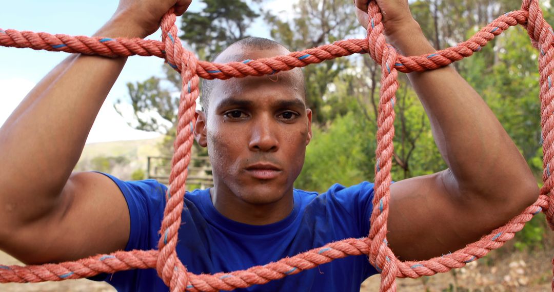 Focused Athlete Climbing Rope Net in Outdoor Obstacle Course - Free Images, Stock Photos and Pictures on Pikwizard.com