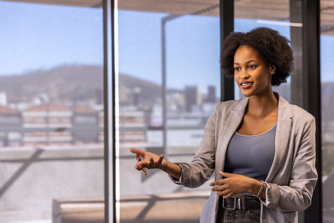 Confident Businesswoman Presenting in Modern Office Setting