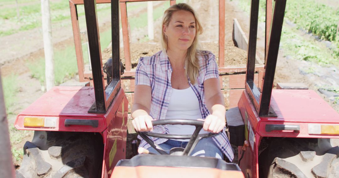 Woman driving tractor on farm - Free Images, Stock Photos and Pictures on Pikwizard.com