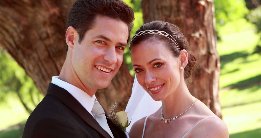 Newlywed Couple Embracing in Sunlit Park