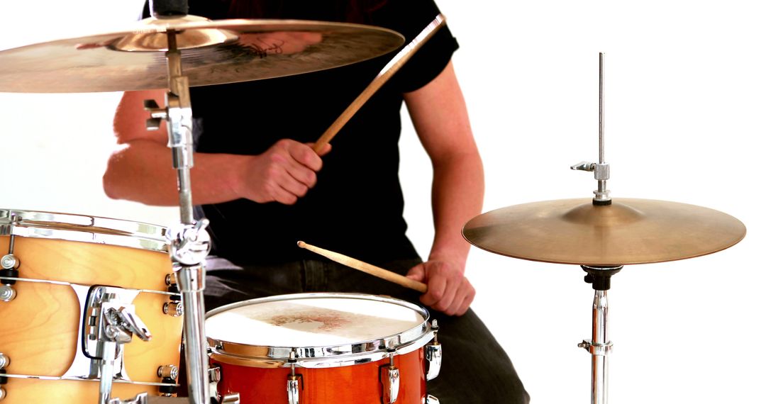 Drummer playing his drum kit on white background - Free Images, Stock Photos and Pictures on Pikwizard.com