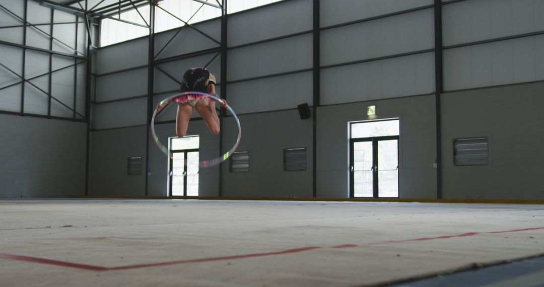 Gymnast Practicing with Hula Hoop in Indoor Sports Hall - Free Images, Stock Photos and Pictures on Pikwizard.com