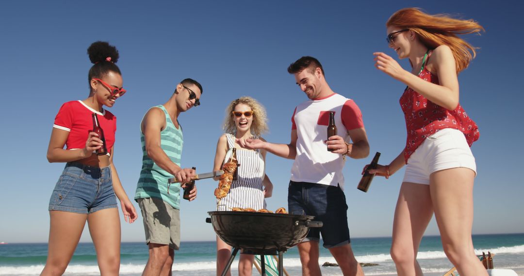 Friends Enjoying Beach Barbecue on Sunny Day - Free Images, Stock Photos and Pictures on Pikwizard.com