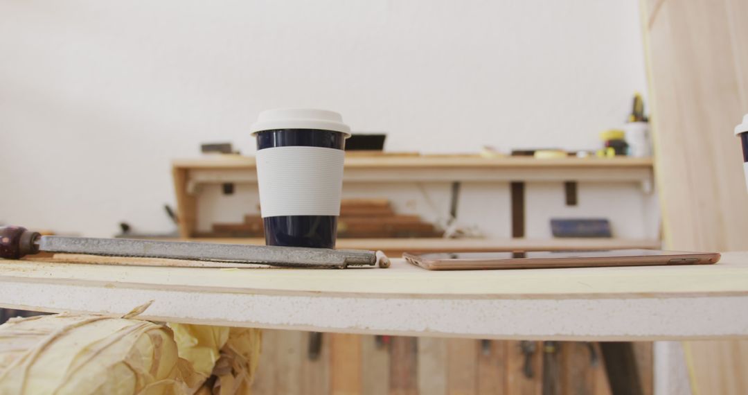 Cup of Coffee on Woodwork Table in Workshop - Free Images, Stock Photos and Pictures on Pikwizard.com