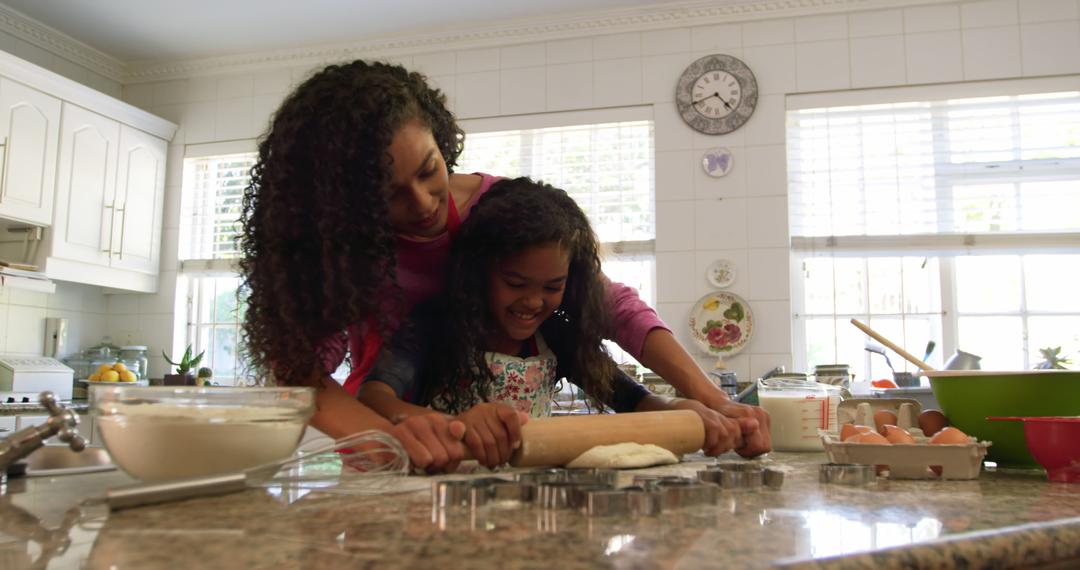 Young Biracial Woman Teaching Daughter Baking at Home - Bonding over Cookies in Sunny Kitchen - Free Images, Stock Photos and Pictures on Pikwizard.com