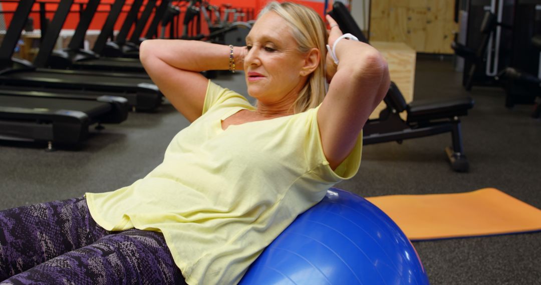 Senior Woman Exercising with Stability Ball at Gym - Free Images, Stock Photos and Pictures on Pikwizard.com