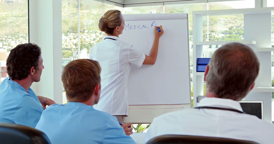 Medical Professionals in a Training Session with a Flipchart - Free Images, Stock Photos and Pictures on Pikwizard.com