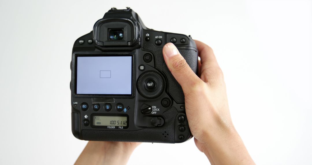 Photographer Adjusting Settings on Professional DSLR Camera - Free Images, Stock Photos and Pictures on Pikwizard.com