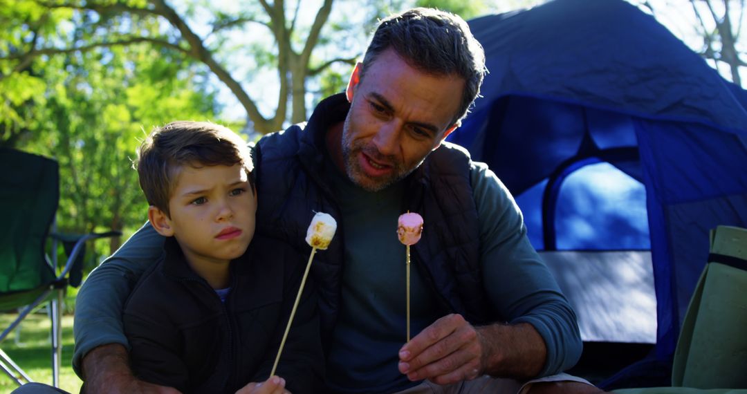 Father and Son Roasting Marshmallows in Outdoor Camping - Free Images, Stock Photos and Pictures on Pikwizard.com