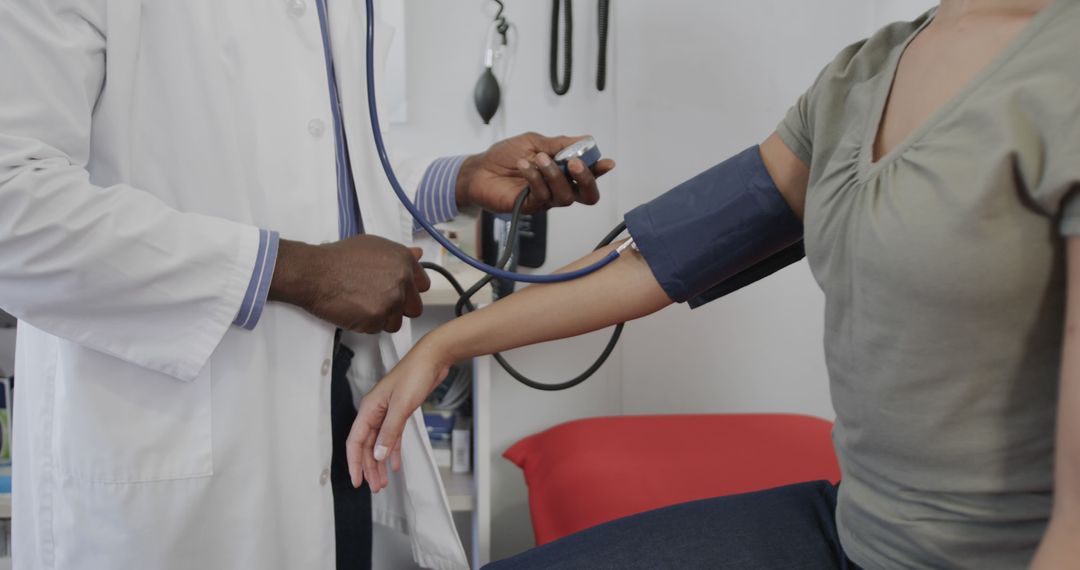 Doctor measuring patient's blood pressure with sphygmomanometer - Free Images, Stock Photos and Pictures on Pikwizard.com