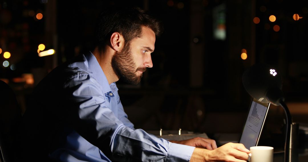 Businessman Working Late on Laptop in Office - Free Images, Stock Photos and Pictures on Pikwizard.com