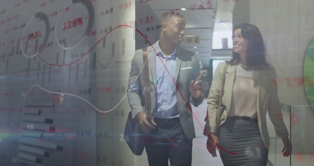 Business Colleagues Analyzing Financial Data in Modern Office Environment