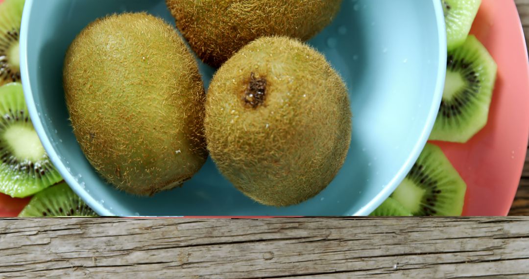 Fresh Kiwis in Bowl on Wooden Table - Free Images, Stock Photos and Pictures on Pikwizard.com