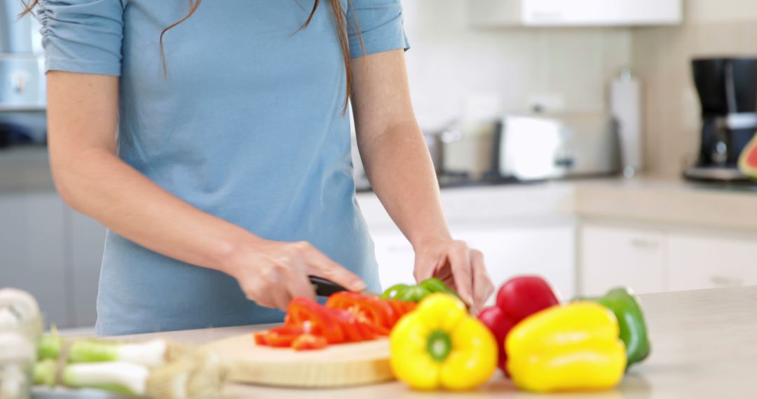 Smiling Woman Preparing Vegetables in Modern Home Kitchen - Free Images, Stock Photos and Pictures on Pikwizard.com