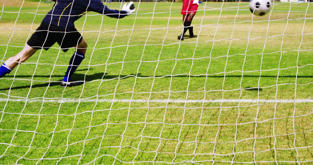 Goalie Making Save During Soccer Match on Green Field - Free Images, Stock Photos and Pictures on Pikwizard.com