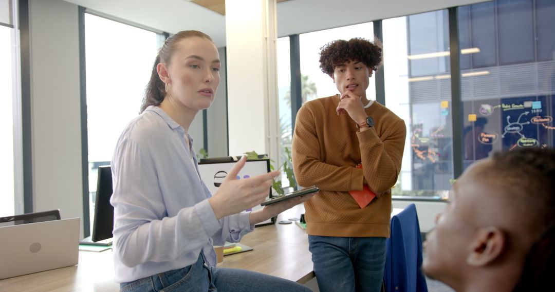 Colleagues Collaborating in Modern Office Setting with Technology