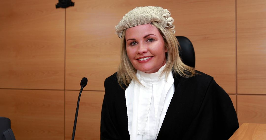 Smiling Female Judge in Traditional Court Attire Seated in Courtroom - Free Images, Stock Photos and Pictures on Pikwizard.com