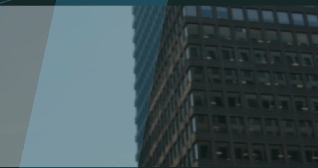 Office Skyscraper Facade with Dark Windows Under Blue Sky