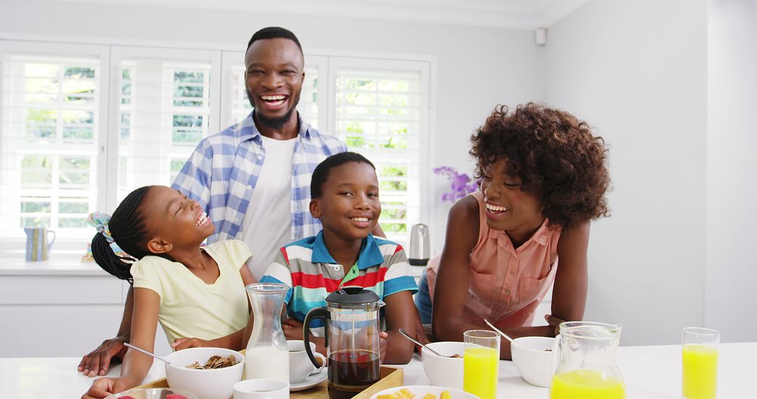 Smiling African American Family Enjoying Breakfast Together in Bright Kitchen - Free Images, Stock Photos and Pictures on Pikwizard.com